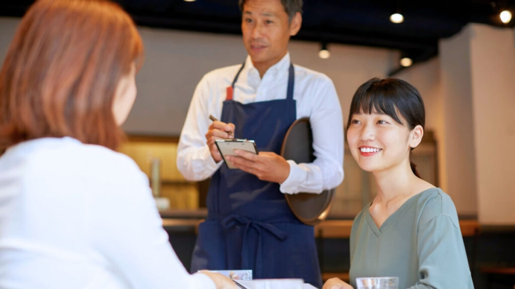カフェで注文を散られている若い女性